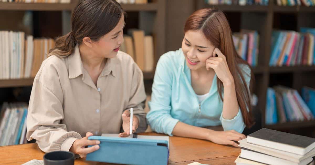 Tutor explaining physics formulas to student